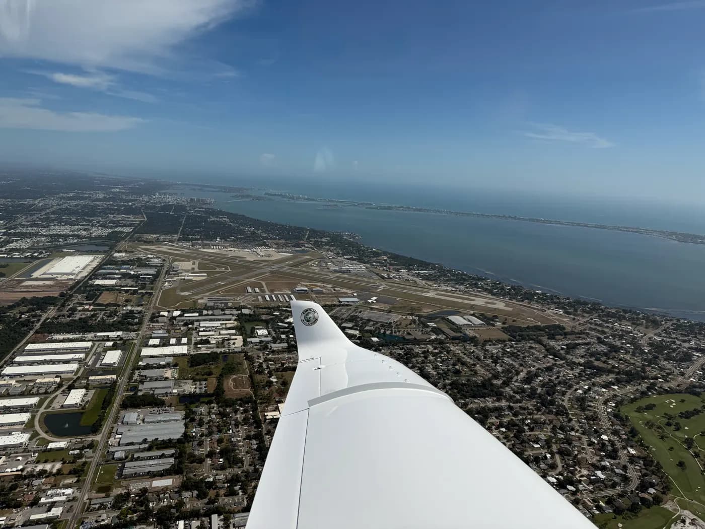 Over a coastal city and its airport