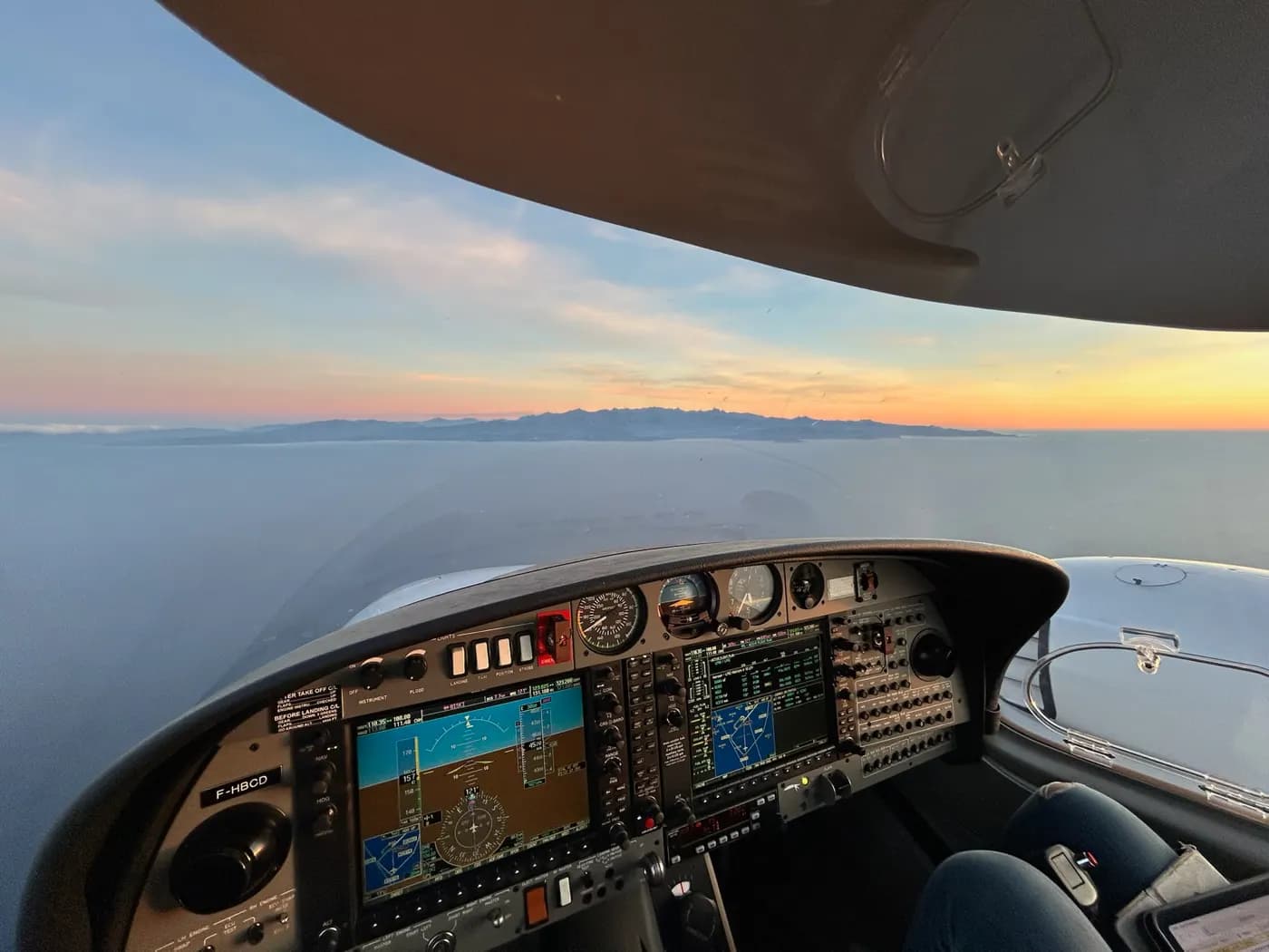 Cockpit at sunset above the clouds
